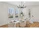 Inviting dining area with a white table, stylish chairs, and natural light from the adjacent windows at 9900 Summer Ash Ct # 103, Las Vegas, NV 89134