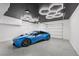 Spacious garage features epoxy flooring, modern lighting and plenty of room for storage and a car at 9900 Summer Ash Ct # 103, Las Vegas, NV 89134