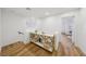 Bright hallway featuring wood floors, decorative console table, and an open doorway to another room at 9900 Summer Ash Ct # 103, Las Vegas, NV 89134
