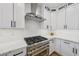 Gourmet kitchen with stainless steel appliances, white cabinetry, quartz countertops, and modern design at 9900 Summer Ash Ct # 103, Las Vegas, NV 89134