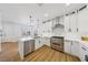 Modern kitchen featuring stainless steel appliances, white cabinetry, quartz countertops, and an open layout at 9900 Summer Ash Ct # 103, Las Vegas, NV 89134