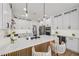 Sleek kitchen showcasing a large island, modern appliances, white cabinetry, and stylish barstool seating at 9900 Summer Ash Ct # 103, Las Vegas, NV 89134