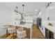Modern kitchen boasts white cabinets, stainless steel appliances, a center island and pendant lighting at 9900 Summer Ash Ct # 103, Las Vegas, NV 89134