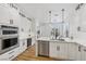 Bright kitchen with stainless steel appliances, a wine cooler, and white cabinets and countertops at 9900 Summer Ash Ct # 103, Las Vegas, NV 89134