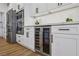 Kitchen featuring stainless steel appliances, including a beverage fridge, built-in oven, and sleek white cabinetry at 9900 Summer Ash Ct # 103, Las Vegas, NV 89134