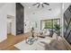 Open living room featuring a fireplace, vaulted ceiling, and access to the outdoor patio area at 9900 Summer Ash Ct # 103, Las Vegas, NV 89134