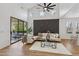 Open living room leading to patio with stylish decor, plenty of seating, and a modern accent wall at 9900 Summer Ash Ct # 103, Las Vegas, NV 89134