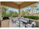 Inviting outdoor patio with stylish furniture, a built-in BBQ, and a tranquil garden view at 9900 Summer Ash Ct # 103, Las Vegas, NV 89134