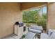 Inviting outdoor patio with a built-in BBQ, and a tranquil garden view at 9900 Summer Ash Ct # 103, Las Vegas, NV 89134