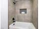 Close-up of the shower with tiled walls and a built-in niche for storage at 9900 Summer Ash Ct # 103, Las Vegas, NV 89134