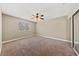 Inviting bedroom with neutral walls, broadloom carpet, a ceiling fan, and a mirrored closet at , Las Vegas, NV 89134