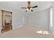 Neutral bedroom featuring tile flooring, ceiling fan, mirrored closet doors, and a large window for natural light at , Las Vegas, NV 89134