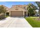 Inviting two-story home showcases a tile roof, well-maintained lawn, and a spacious driveway, blending comfort and style at , Las Vegas, NV 89134
