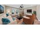 Bright, staged living room with neutral walls, tile floors, and a ceiling fan at , Las Vegas, NV 89134