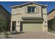 Two-story home featuring a neutral-toned facade, a two-car garage, and a well-maintained, stylish brick driveway at 10434 Luna Mezzo St Ave # Lot 188, Las Vegas, NV 89141