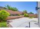 Low-maintenance backyard features decorative rock, concrete patio and privacy walls at 10434 Rose Palisade St, Las Vegas, NV 89141