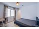 Bedroom featuring light wood floors and a desk by the window provides ample workspace at 10434 Rose Palisade St, Las Vegas, NV 89141