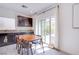 Bright dining area with modern table set, stylish cabinetry, and sliding glass doors to the outdoor area at 10434 Rose Palisade St, Las Vegas, NV 89141