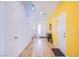Hallway with light wood floors, white walls and doors leads to stairs and other rooms at 10434 Rose Palisade St, Las Vegas, NV 89141
