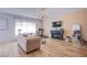 Open concept living room with hardwood floors, fireplace, and chandelier at 10434 Rose Palisade St, Las Vegas, NV 89141