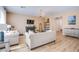 Open-concept living room with hardwood floors, a fireplace, and neutral decor, blending comfort with modern design at 10434 Rose Palisade St, Las Vegas, NV 89141