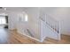Staircase with light wood floors and white banisters provides access to multiple floors at 10434 Rose Palisade St, Las Vegas, NV 89141