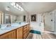 Bathroom featuring double sinks, a soaking tub, and a separate glass-enclosed shower at 10809 Garden Mist Dr # 1042, Las Vegas, NV 89135