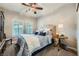 Cozy bedroom with a ceiling fan, window shutters, and upholstered headboard at 10809 Garden Mist Dr # 1042, Las Vegas, NV 89135