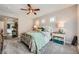Inviting bedroom featuring three windows, a ceiling fan, and neutral décor at 10809 Garden Mist Dr # 1042, Las Vegas, NV 89135