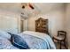 Serene bedroom with dark wood armoire, ceiling fan, and soft color palette at 10809 Garden Mist Dr # 1042, Las Vegas, NV 89135