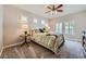 Comfortable bedroom with a ceiling fan, window shutters, and stylish floral bedding at 10809 Garden Mist Dr # 1042, Las Vegas, NV 89135
