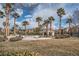 Exterior shot of community pool, mature palms, and lush lawn surrounding a desert oasis at 10809 Garden Mist Dr # 1042, Las Vegas, NV 89135