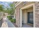 Inviting entryway with stone accents and a welcoming door mat that reads 'hope you brought wine' at 10809 Garden Mist Dr # 1042, Las Vegas, NV 89135