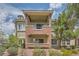 Attractive building exterior with beautiful landscaping and a charming covered patio at 10809 Garden Mist Dr # 1042, Las Vegas, NV 89135