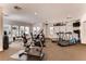 Well-equipped community fitness center with various cardio machines, weights, and natural light at 10809 Garden Mist Dr # 1042, Las Vegas, NV 89135