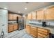 Bright kitchen featuring wood cabinets, stainless steel appliances, and granite countertops at 10809 Garden Mist Dr # 1042, Las Vegas, NV 89135