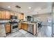 Bright kitchen with granite countertops, stainless steel appliances, and wood cabinets at 10809 Garden Mist Dr # 1042, Las Vegas, NV 89135