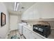 Well-equipped laundry room with white cabinets, sink, and modern washer and dryer at 10809 Garden Mist Dr # 1042, Las Vegas, NV 89135