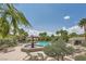 Resort-style community pool with fountain, lounge chairs, palm trees, and clear blue water at 10809 Garden Mist Dr # 1042, Las Vegas, NV 89135