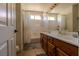 Bathroom featuring a double vanity with wood cabinets and a shower-tub combination at 10949 Fintry Hills St, Las Vegas, NV 89141