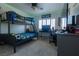 A bedroom with bunkbeds, desk, chair, and storage unit at 10949 Fintry Hills St, Las Vegas, NV 89141