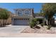 Beautiful two-story home with a landscaped yard, desert landscaping, and a spacious two-car garage at 10949 Fintry Hills St, Las Vegas, NV 89141