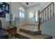 Bright foyer with tile flooring, staircase, a decorative front door and a side window at 10949 Fintry Hills St, Las Vegas, NV 89141