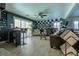 Bright living room with tile flooring, large windows, and comfortable seating at 10949 Fintry Hills St, Las Vegas, NV 89141