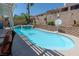 Backyard pool with blue water and decorative tile, enhanced by privacy landscaping at 10949 Fintry Hills St, Las Vegas, NV 89141