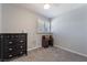 Bedroom featuring gray carpet and walls, a dark wood dresser, and a window with shutters at 1407 Dorothy Ave # 2, Las Vegas, NV 89119