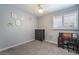 Cozy bedroom with gray walls, plush carpet, and a window with plantation shutters at 1407 Dorothy Ave # 2, Las Vegas, NV 89119