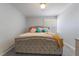 Bedroom with neutral tones, a tufted headboard, and plantation shutters for natural light at 1407 Dorothy Ave # 2, Las Vegas, NV 89119
