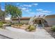 Unique home exterior with an arched entryway, desert landscaping, and modern design at 1407 Dorothy Ave # 2, Las Vegas, NV 89119