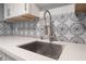 Close-up on the stylish kitchen sink and backsplash against a white countertop at 1407 Dorothy Ave # 2, Las Vegas, NV 89119